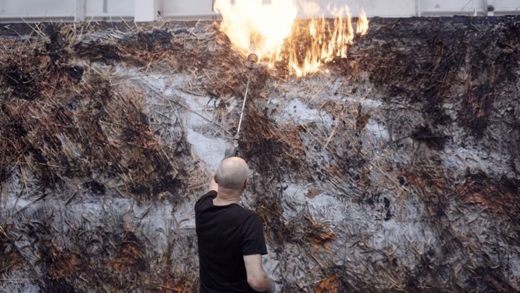 Consider Anselm Kiefer's massive installations using materials like lead, ash, straw, and books